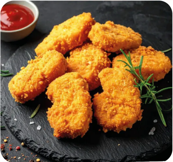 Golden chicken nuggets on a slate board