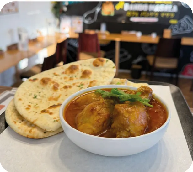 Chicken curry in a bowl with naan