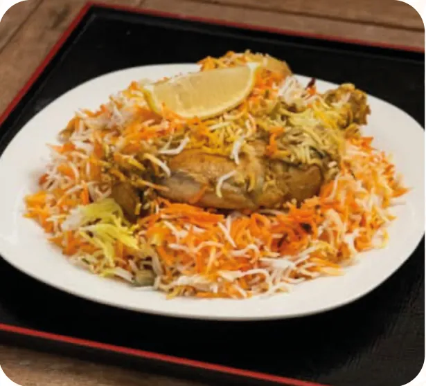 Chicken biryani with basmati rice and a lemon slice